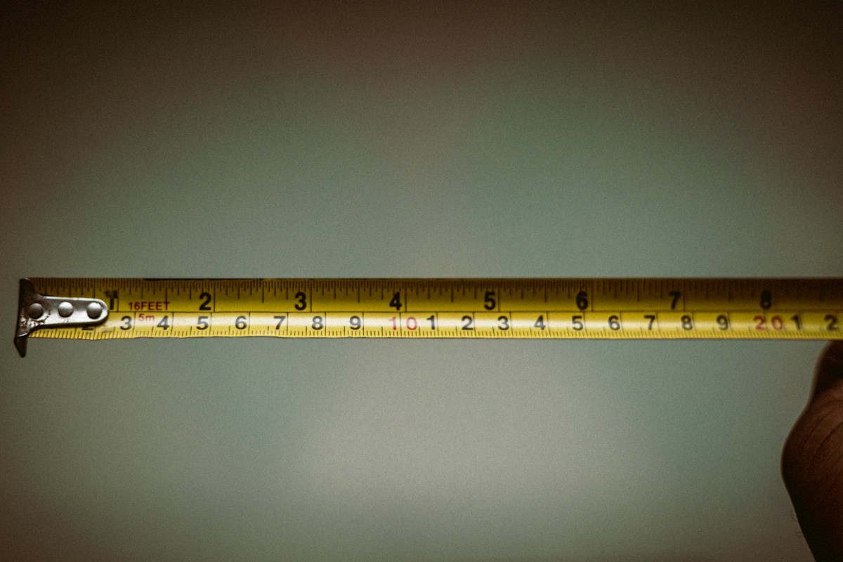 Extended metal tape measure showing centimetres and inches
